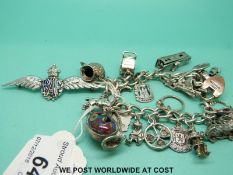A silver charm bracelet with a 9ct gold padlock charm and an RAF badge