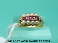 A 15ct gold ring set with seed pearls and rubies (size L)