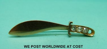 A yellow metal brooch in the form of a kukri set with old cut diamonds