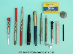 A quantity of pens, silver propelling pencils including an Art Deco enamel example,