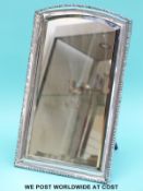 A hallmarked silver framed bevelled edge dressing table mirror with easel back, overall size 33.