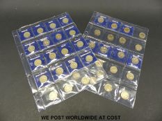 Fifty collectable one pound coins in collector's pockets, including Belfast, Rose, Thistle,