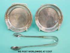 Two hallmarked silver pin dishes, diameter 8cm, and a pair of sugar nips,