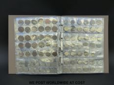 A folder of UK and overseas coins, pre and post decimal, includes modern crowns etc,