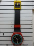 A multicoloured Swatch wall watch in box (26cm diameter dial)