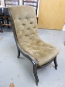 An upholstered Victorian ebonised nursing chair