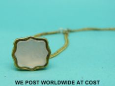 A Victorian yellow metal chain and watch key set with an intaglio seal.