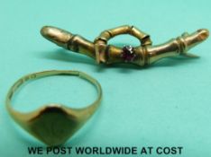 A 9ct gold ring and a 9ct gold brooch set with a garnet (3.