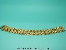 A yellow metal bracelet with stud work decoration, marked 585 (48.