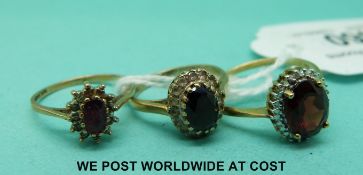 Two yellow metal rings marked 9ct gold and a 9ct gold ring set with rubies and diamonds