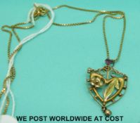An Edwardian pendant set with garnets on an 18ct gold chain