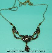 A late Victorian or early Edwardian 9ct gold necklace set with bohemian cut garnets