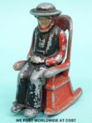 A novelty cruet formed as an Amish/Quaker man on a rocking chair (H8.