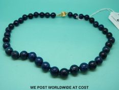 A necklace of lapis lazuli beads with 18ct gold clasp