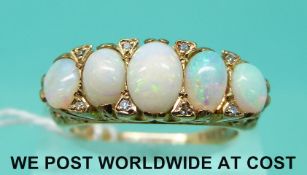 A 9ct gold ring set with five opal cabochons and eight diamonds (size Q)