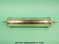 A white metal Indian scroll holder with engraved inscription 