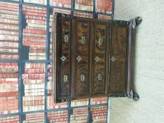 A carved 19thC continental walnut and pine chest of four graduated drawers raised on gnurled feed