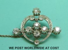An 18ct gold brooch set with diamonds, the three diamonds to the outer edge each approximately 0.