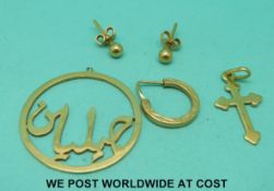 A yellow metal pendant,