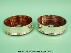 A pair of feature hallmarked silver mounted wine coasters, London 1998, maker's mark WEV,