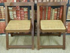 A pair of folding bergere chairs