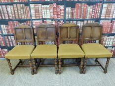 Four upholstered oak chairs with panelled backs