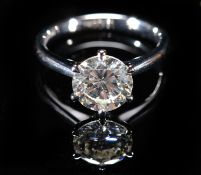 A platinum ring set with a modern round brilliant cut diamond of approximately 2.