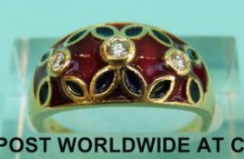 An 18ct gold ring set with three diamonds surrounded by red, blue and green enamel (Size N, 5.