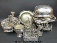 A collection of plated ware including Sheffield plate serving dishes, cruets etc.