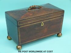 A William IV rosewood and brass inlaid tea caddy with two covered compartments flanking a glass