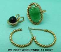 A yellow metal ring set with jadeite,