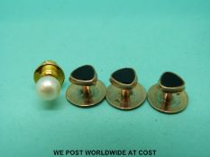 Three 9ct gold studs set with oynx and a pearl stud.