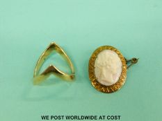 A yellow metal brooch set with a cameo and a yellow metal ring marked 9ct