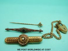 A Victorian yellow metal brooch with compartment verso, a stick pin,