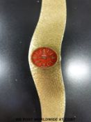 Omega 18ct gold ladies wristwatch with gold hands and markers and red speckled face,