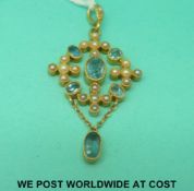 An Edwardian pendant marked 15ct set with seed pearls and topaz