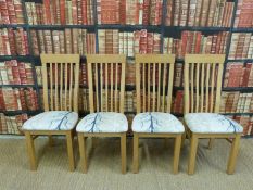 Four upholstered light oak chairs