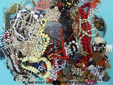 A large collection of costume jewellery to include various brooches, tigers eye pendant, beads, etc.