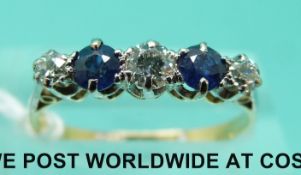 An 18ct gold ring set with three diamonds and two sapphires (size N)