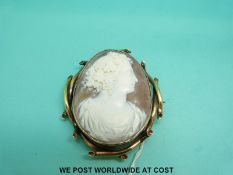 A yellow metal brooch set with a large cameo