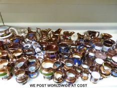 A very large collection of Victorian and early 20thC copper lustre ware jugs and vessels including