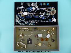 A quantity of costume jewellery to include necklaces, brooches,