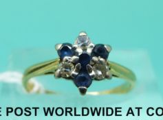 An 18ct gold ring set with sapphires and diamonds in a cluster (size I/J)