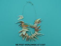 A shell necklace made up of over 50 irregular pieces.