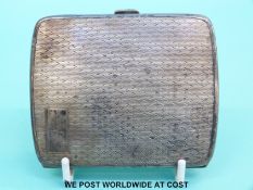 A hallmarked silver cigarette case with engine turned decoration (106g)
