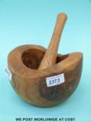 An olive wood pestle and mortar