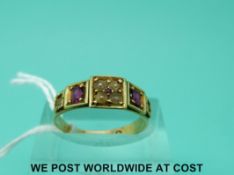 A yellow metal ring set with seed pears and rubies (size M)