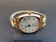 A cushion shaped 9ct gold gentleman's wristwatch with blued hands,