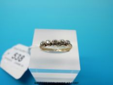 A yellow metal ring marked 18ct set with five diamonds size K (1.