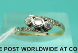 An 18ct gold ring set with three diamonds in a platinum setting,